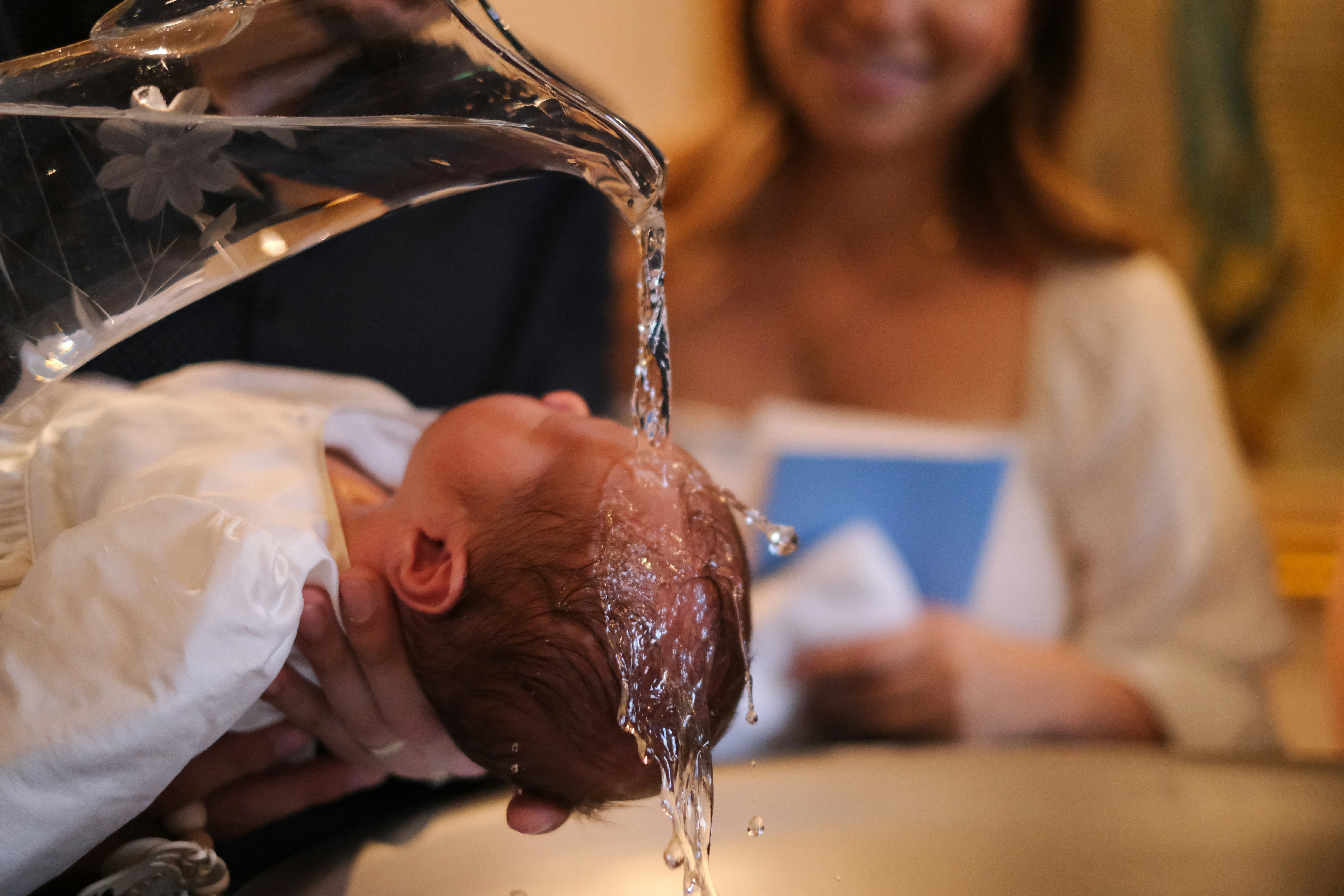 A baby being baptised during a christening ceremony